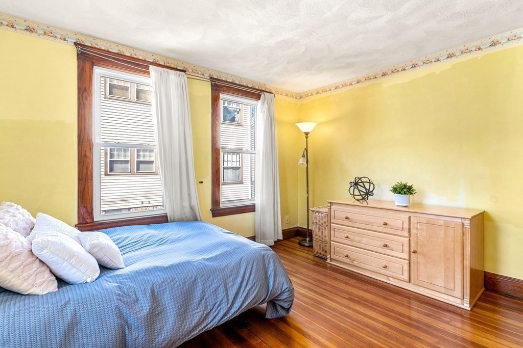 86 Howard Street, Unit 1 Waltham, MA 02451 - Photo 29 of 40 a bedroom with a bed and with furniture