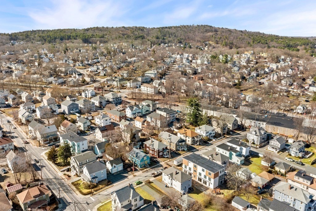 86 Howard Street, Unit 1 Waltham, MA 02451 - Photo 39 of 40 an aerial view of residential houses with outdoor space and trees