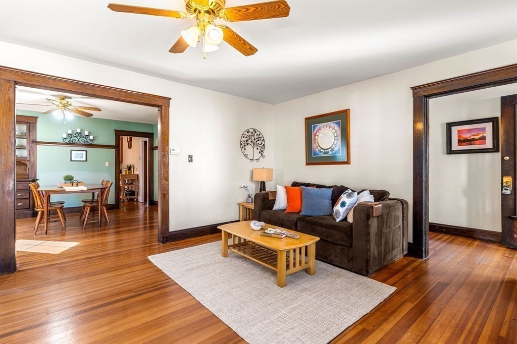 86 Howard Street, Unit 1 Waltham, MA 02451 - Photo 5 of 40 a living room with furniture and a wooden floor