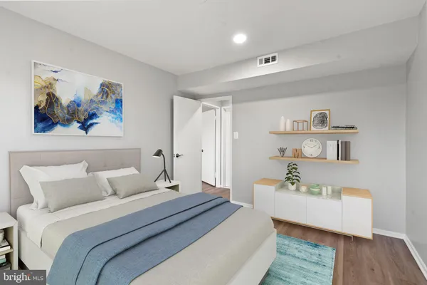 a bedroom with a bed and a couch