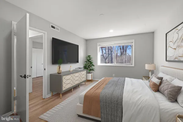 a bedroom with a flat screen television and a bed