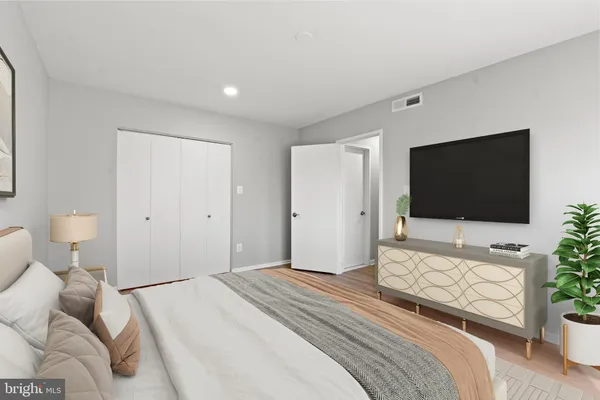 a bedroom with a bed and a flat screen tv