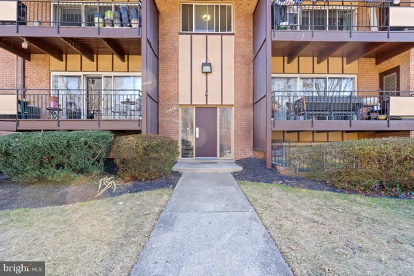 a view of a brick building with a bench in front of building