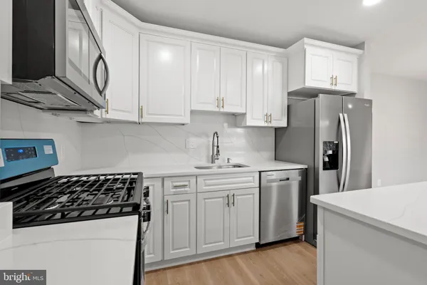 a kitchen with stainless steel appliances a sink and a stove