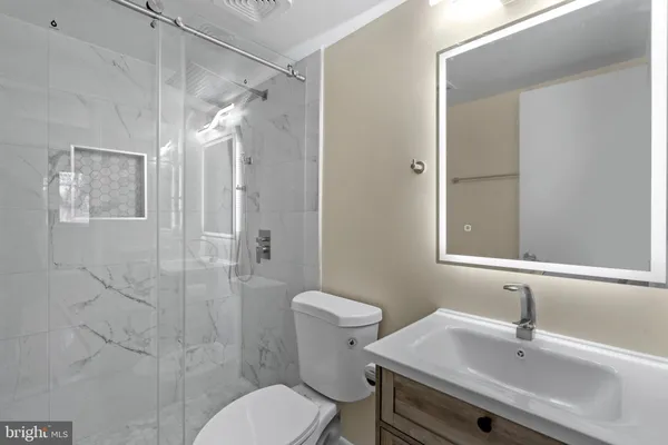 a bathroom with a sink toilet and shower