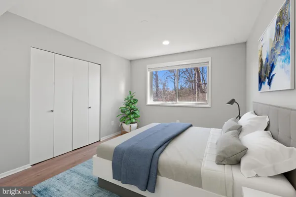 a bedroom with a bed and a painting on the wall