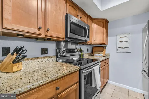 a kitchen with stainless steel appliances granite countertop a stove and a microwave