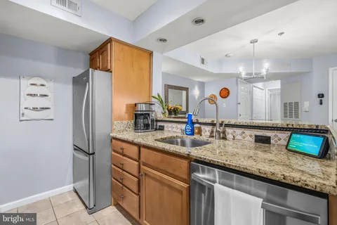 a kitchen with sink refrigerator and microwave