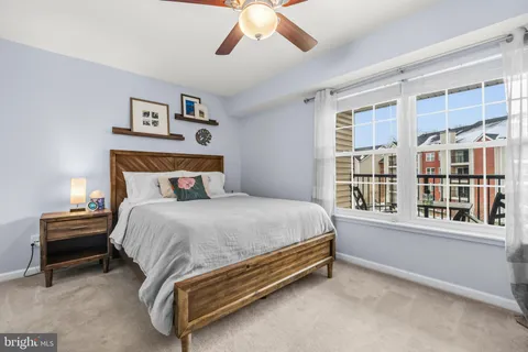 a spacious bedroom with a bed and a large window