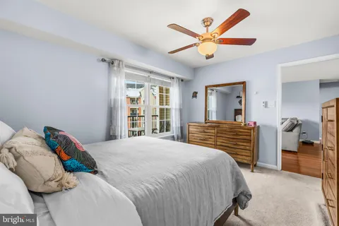 a bedroom with a large bed and a chandelier