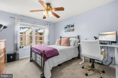 a spacious bedroom with a bed and a chandelier