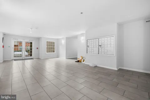 a view of a livingroom with an empty space and a window