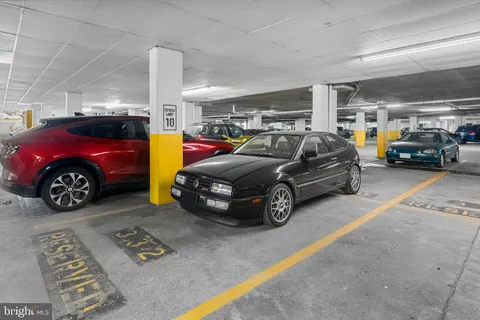 a view of parking garage with cars parked