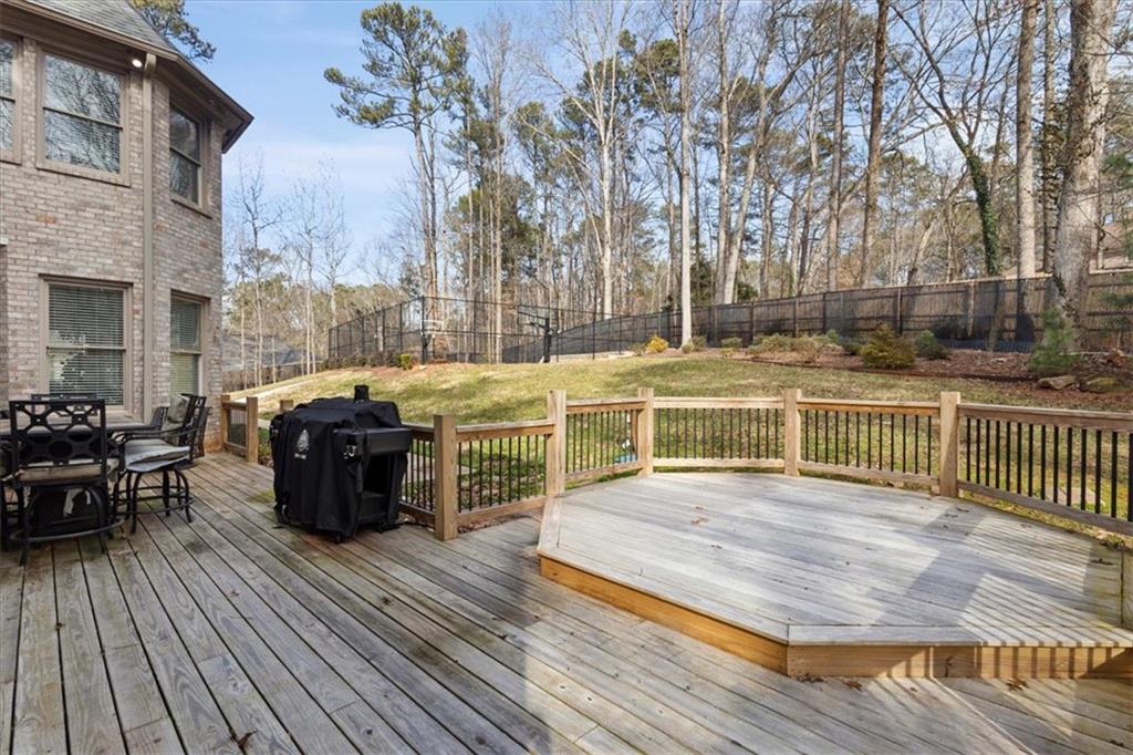 1859 Mountain Shadow Smoke Rise, GA 30087 - Photo 16 of 75 a view of a patio with table and chairs with wooden floor and fence