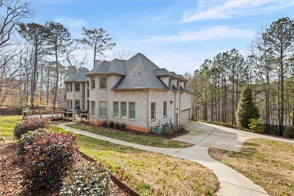 a living room with furniture chandelier and a wooden floor