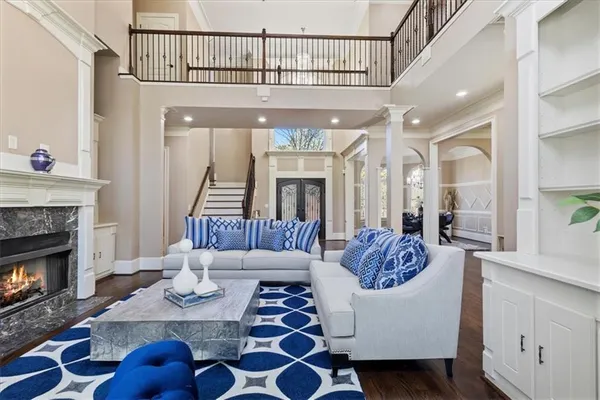 a view of a hallway with wooden floor and windows