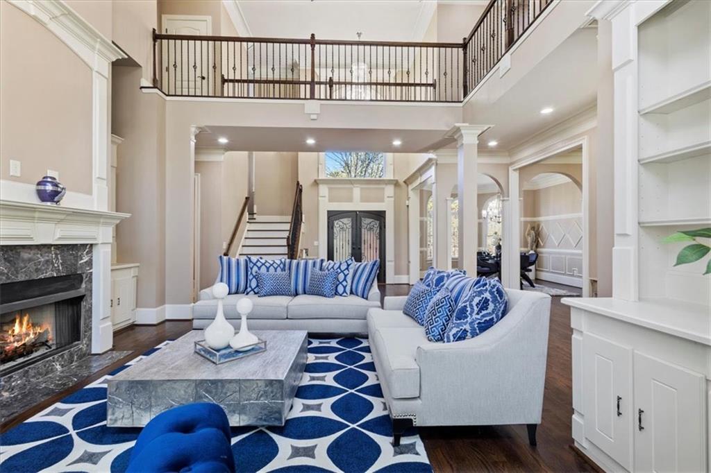 1859 Mountain Shadow Smoke Rise, GA 30087 - Photo 25 of 75 a living room with furniture a fireplace and a chandelier
