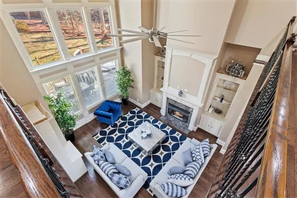 a bedroom with a bed a chandelier and a flat tv screen