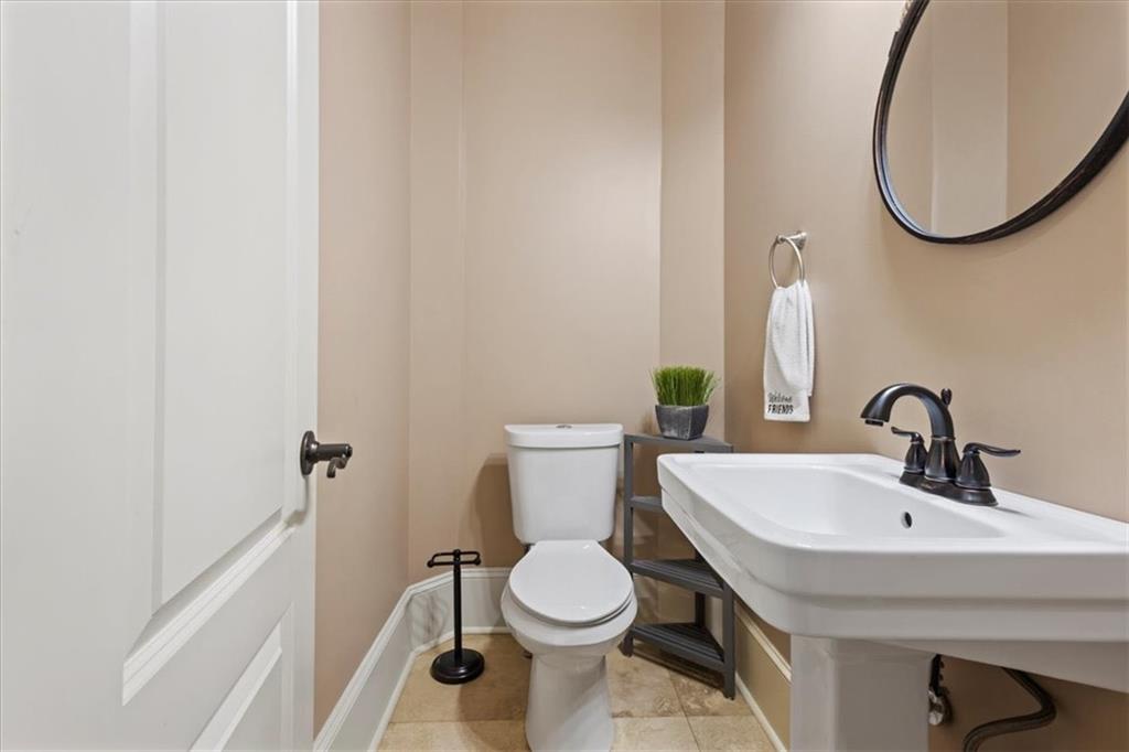 1859 Mountain Shadow Smoke Rise, GA 30087 - Photo 32 of 75 a bathroom with a sink a toilet and a mirror