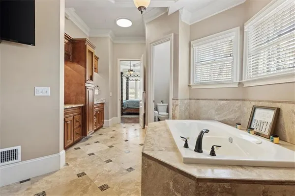 a kitchen with stainless steel appliances granite countertop a stove a sink dishwasher a refrigerator and a oven with wooden floor