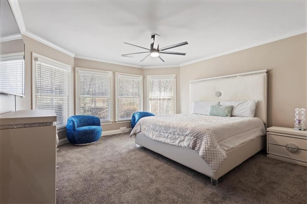 1859 Mountain Shadow Smoke Rise, GA 30087 - Photo 41 of 75 a spacious bedroom with a bed and a couch