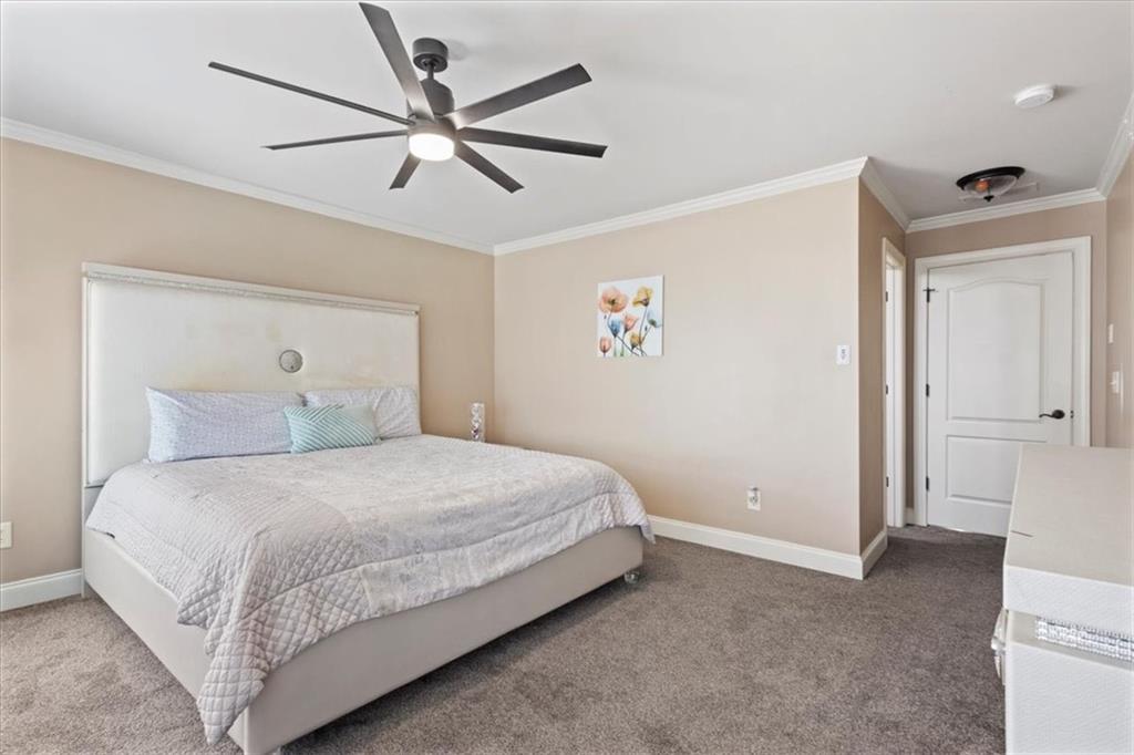 1859 Mountain Shadow Smoke Rise, GA 30087 - Photo 42 of 75 a bedroom with a bed and a ceiling fan
