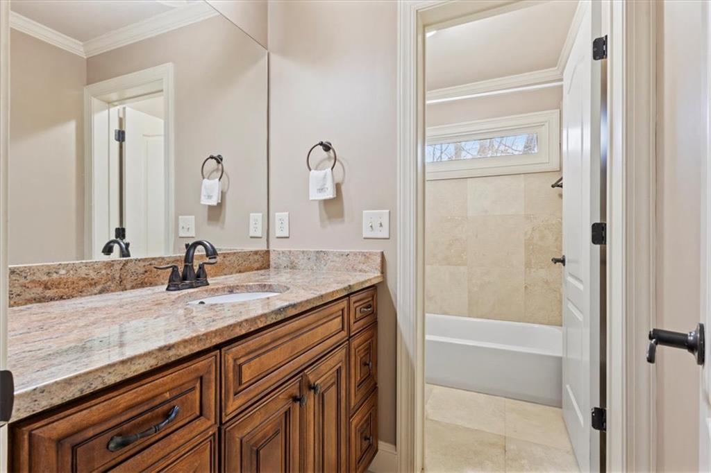 1859 Mountain Shadow Smoke Rise, GA 30087 - Photo 43 of 75 a bathroom with a granite countertop sink and a mirror