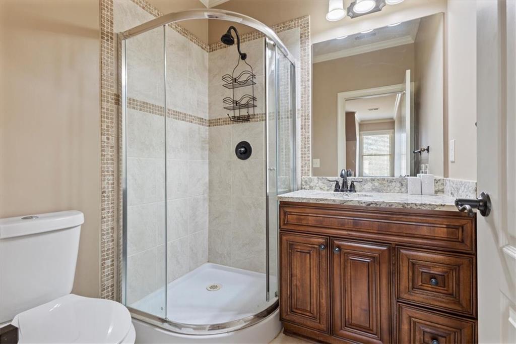 1859 Mountain Shadow Smoke Rise, GA 30087 - Photo 48 of 75 a bathroom with a granite countertop sink toilet and shower
