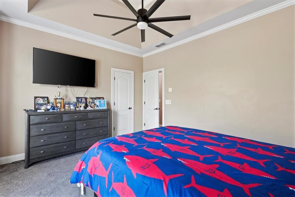 1859 Mountain Shadow Smoke Rise, GA 30087 - Photo 51 of 75 a bedroom with a bed and a flat screen tv