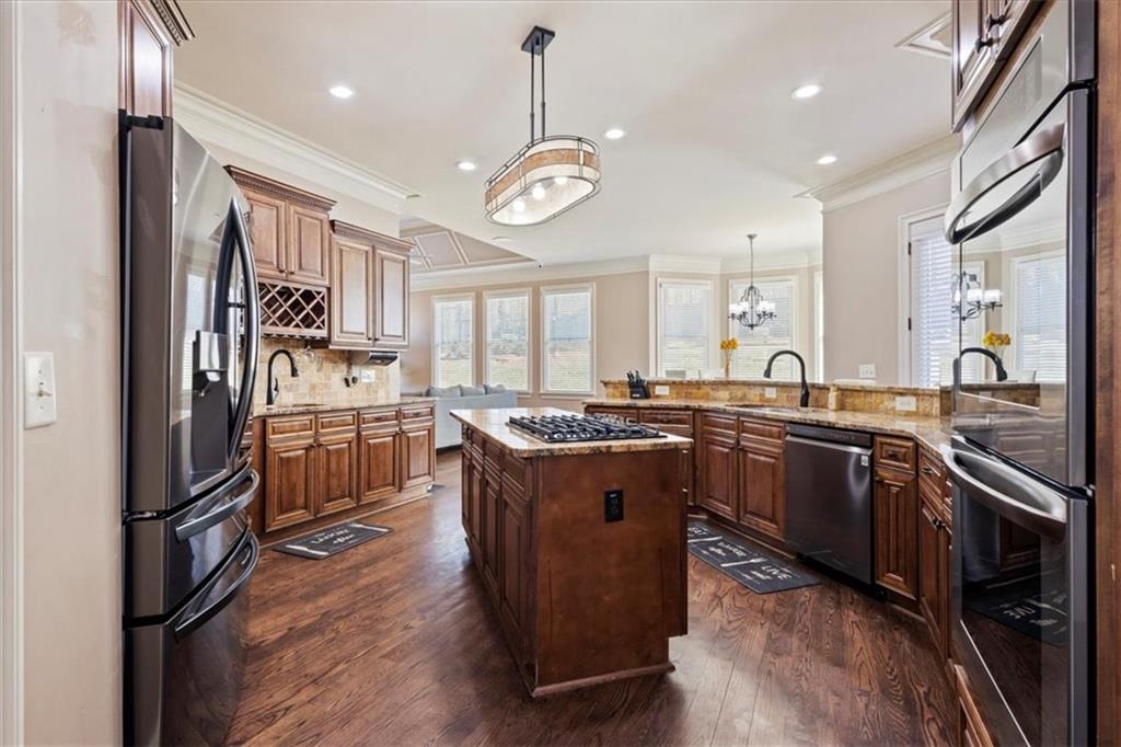 1859 Mountain Shadow Smoke Rise, GA 30087 - Photo 52 of 75 a kitchen with stainless steel appliances granite countertop a stove a sink dishwasher a refrigerator and a oven with wooden floor