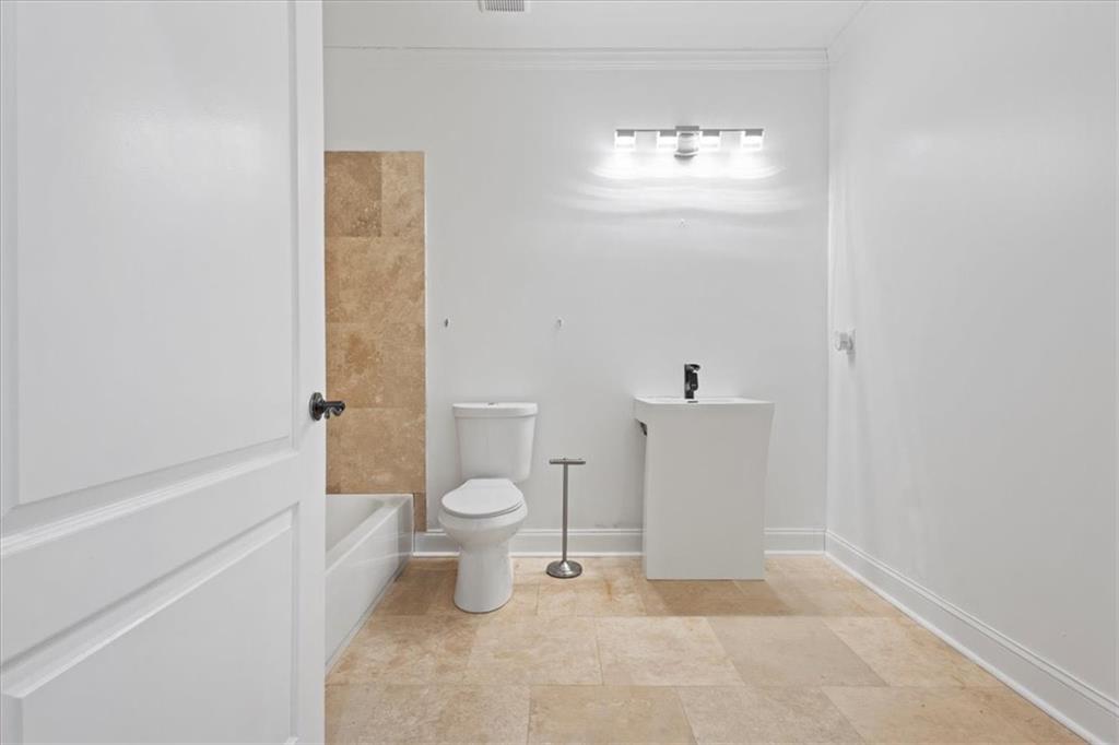 1859 Mountain Shadow Smoke Rise, GA 30087 - Photo 64 of 75 a bathroom with a toilet a sink and a bathtub