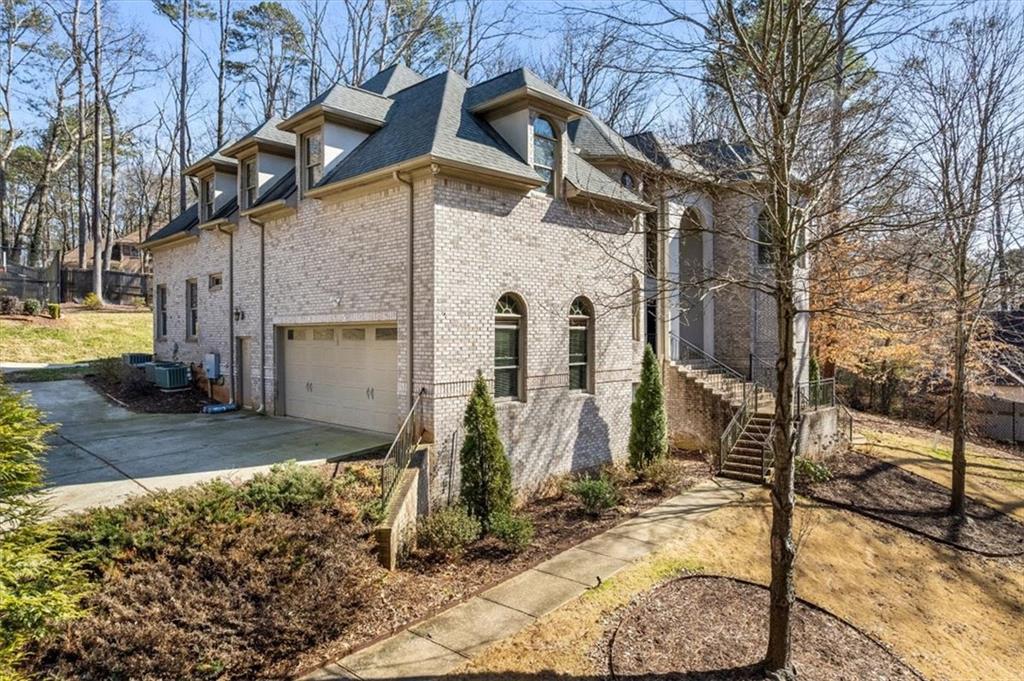 1859 Mountain Shadow Smoke Rise, GA 30087 - Photo 10 of 75 a front view of a house with garden