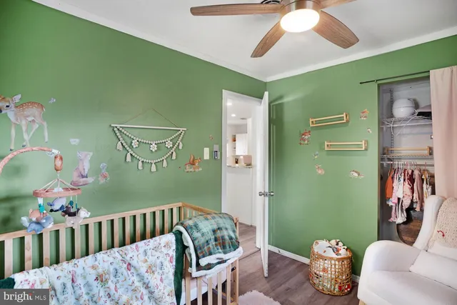 a bedroom with furniture and a chandelier fan