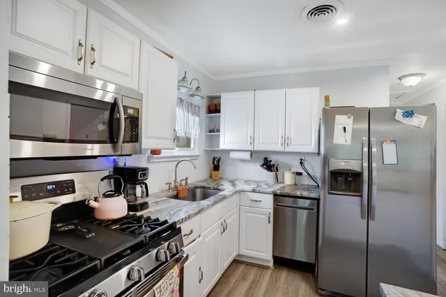 a kitchen with a sink appliances and cabinets