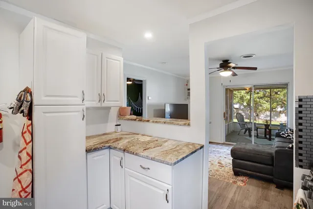 a living room with kitchen island granite countertop furniture and a fireplace