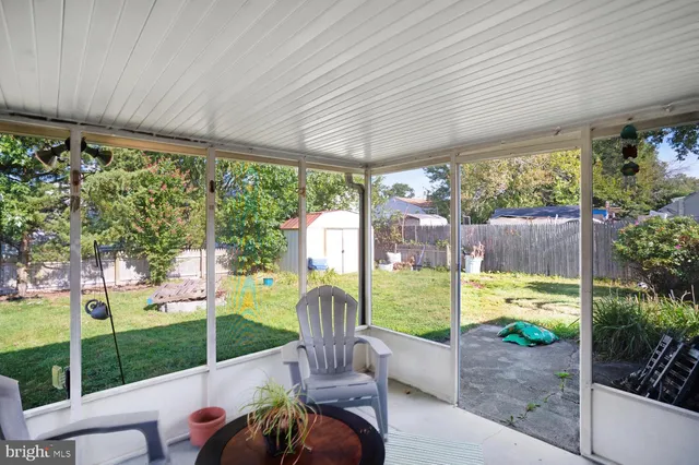 a view of a porch with furniture and garden