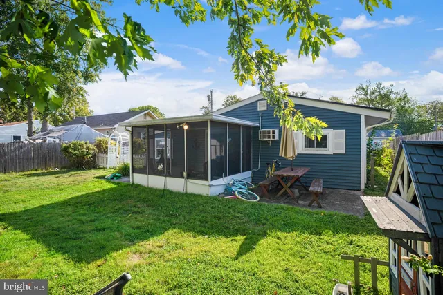 a view of a chair and table in backyard of the house