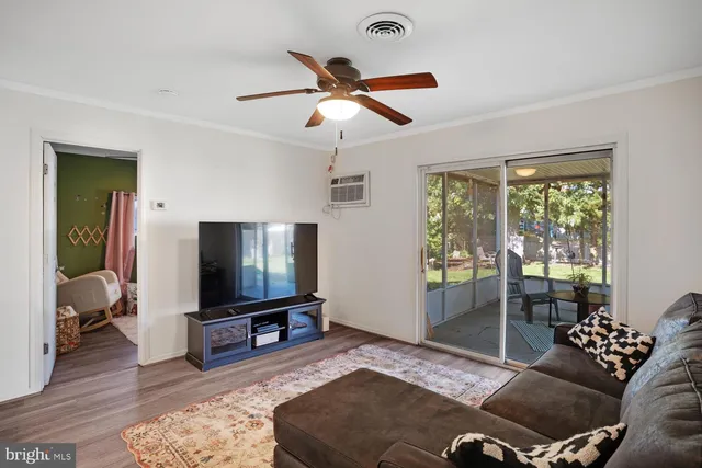 a living room with a flat screen tv and a window