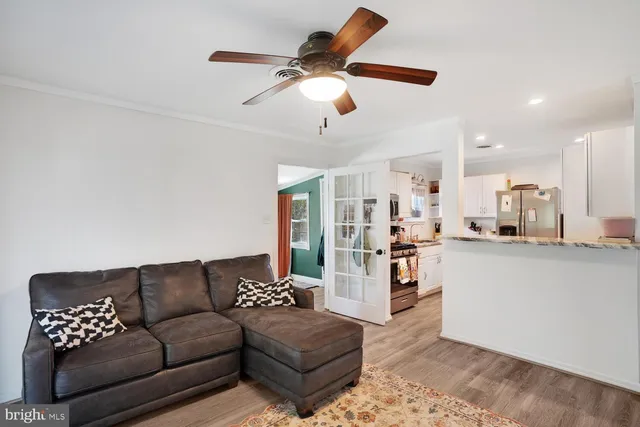 a living room with furniture and kitchen view