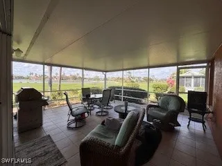 a living room with furniture and floor to ceiling windows