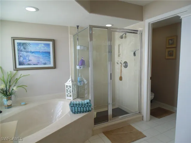 a bathroom with a shower and a bath tub