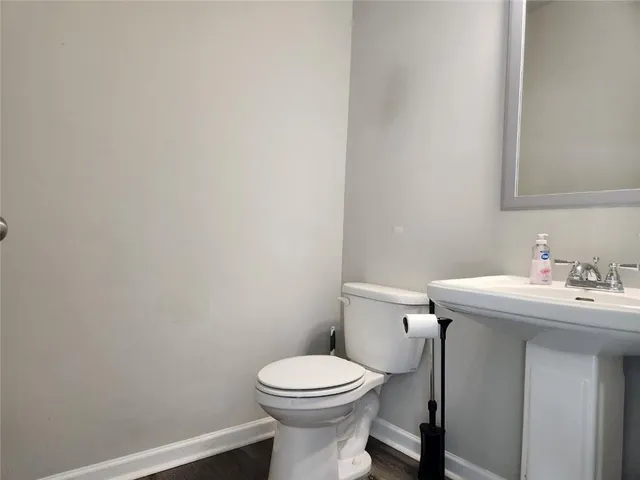 a bathroom with a sink a toilet and a mirror
