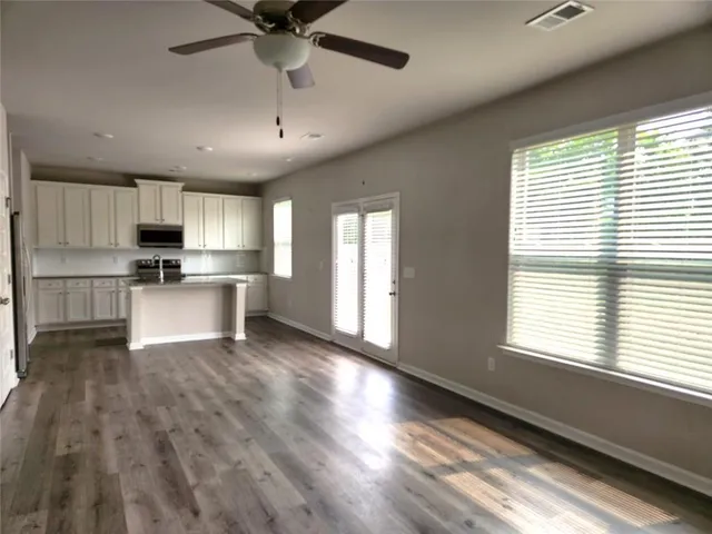 a view of kitchen with sink microwave and refrigerator