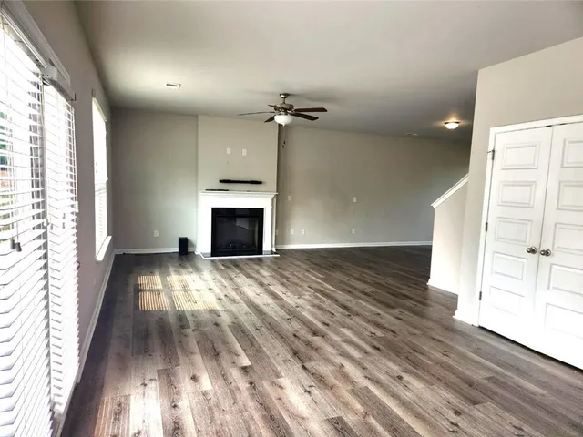 wooden floor in an empty room with a fireplace