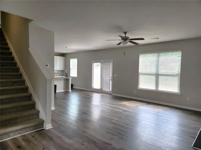 wooden floor in an empty room with a window