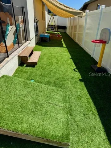 a view of yard with swimming pool