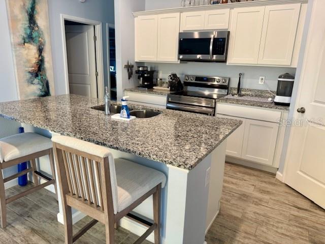 2075 Huntsman Rdg Road Clermont, FL 34715 - Photo 4 of 17 a kitchen with stainless steel appliances granite countertop a stove microwave and sink
