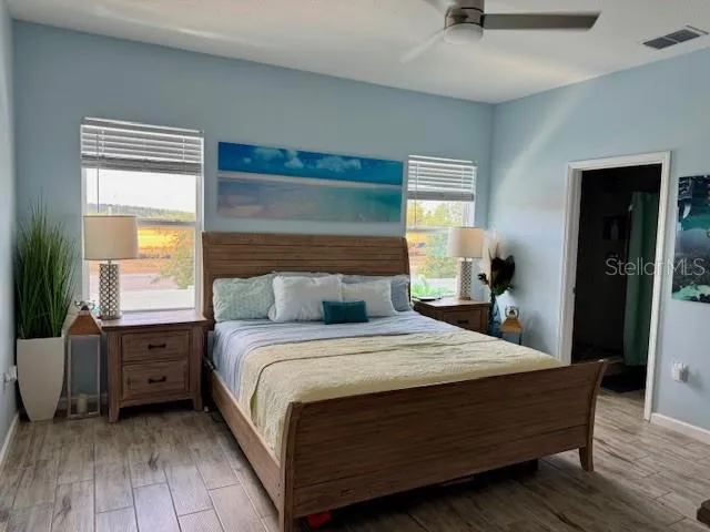 a bed sitting in a bedroom next to a window