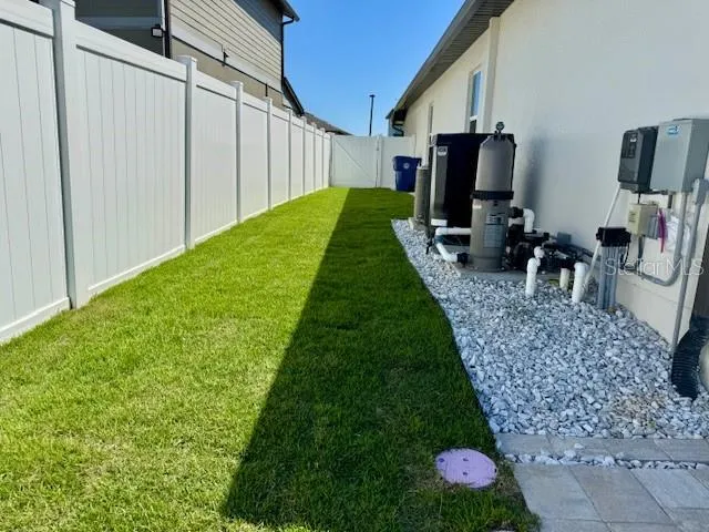 a view of a backyard with chair potted plants