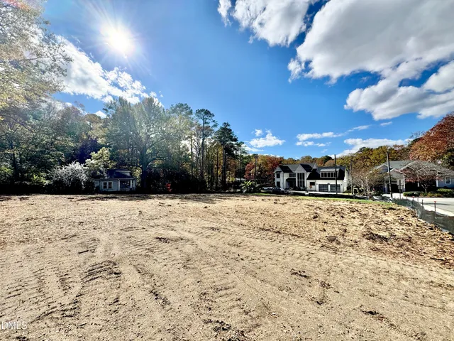 a front view of a house with a yard covered with snow